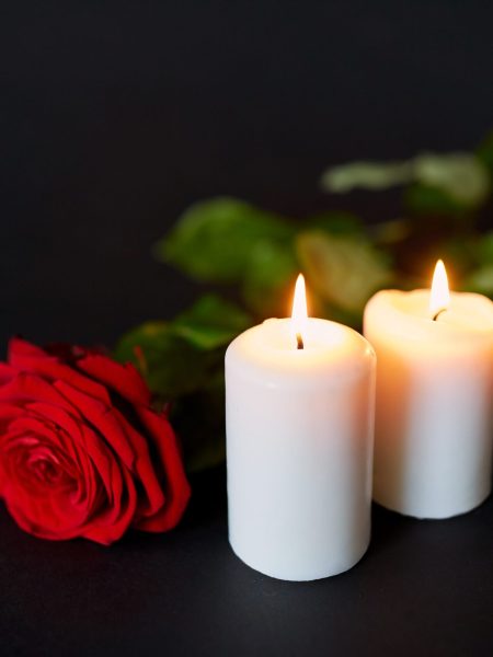 red-rose-and-burning-candles-over-black-background-2022-12-16-09-37-02-utc-scaled.jpg